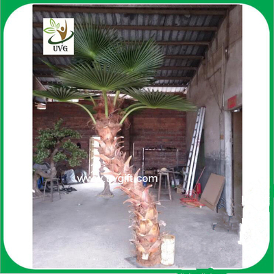 China UVG silk fan leaves artificial coconut palm tree in curved trunk for hotel decoration supplier